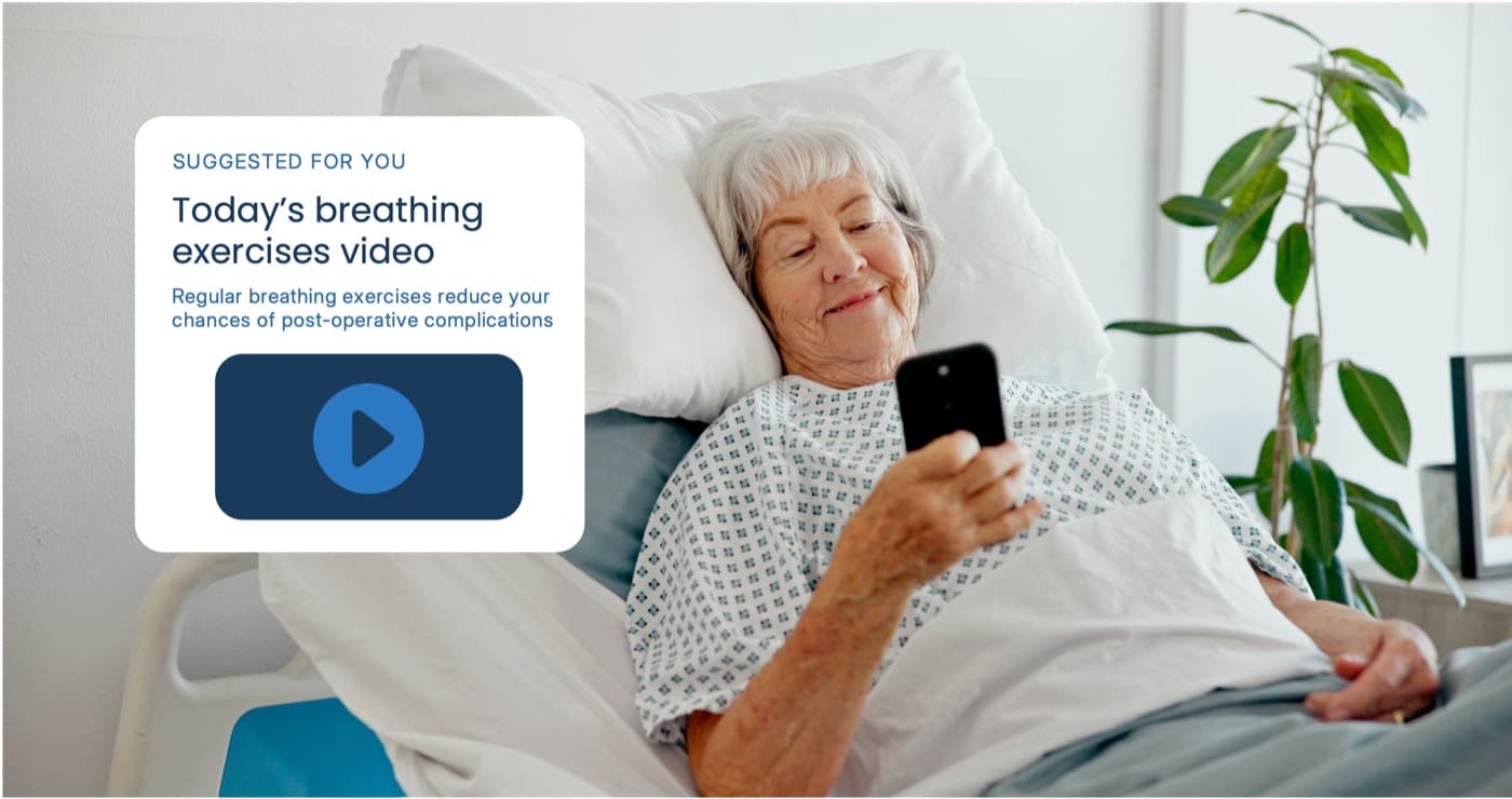 A patient in a hospital bed viewing a 'Suggested for you: Today's breathing exercises video' card on their phone